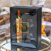 Au Vodka bottle and glasses set in a decorative box with a snowy background
