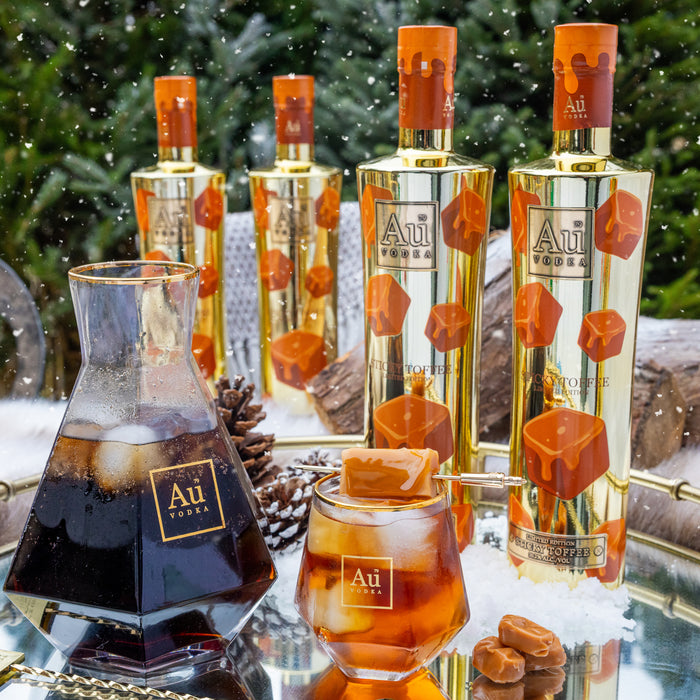 Au Vodka bottles and glasses with a festive background