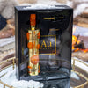 Au Vodka bottle and glass set in a decorative box with a snowy background