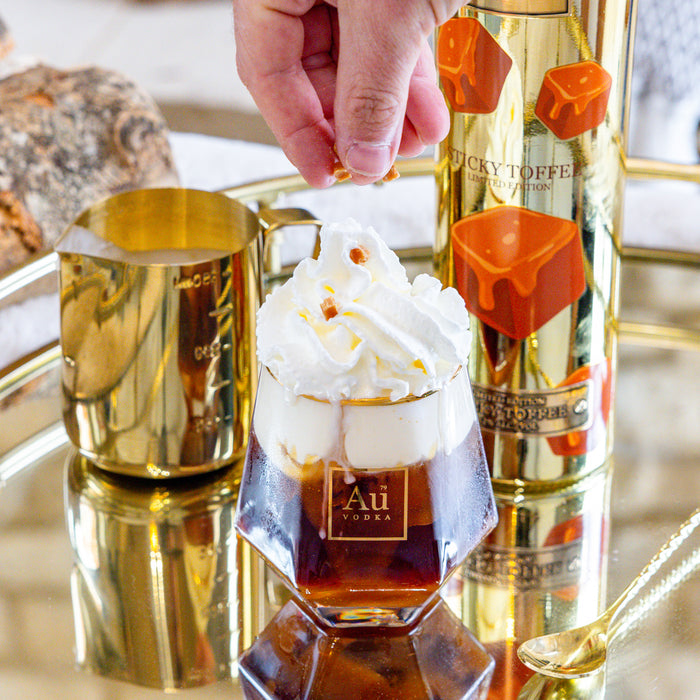 Bottle of Sticky Toffee vodka with a cocktail and whipped cream 