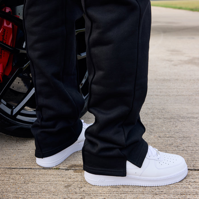 Person wearing black pants and white shoes